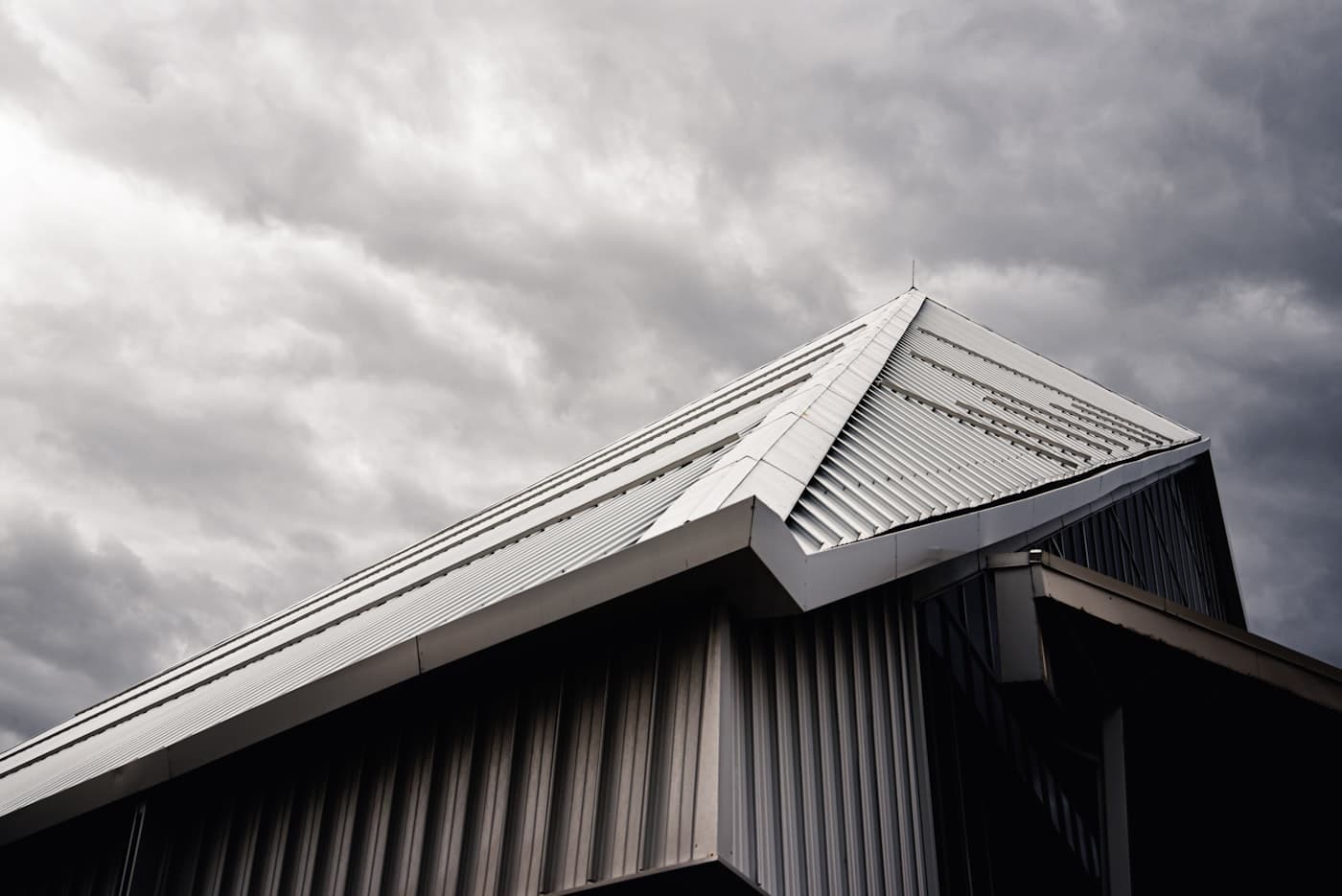 Roof inspector reviewing a residential metal roof